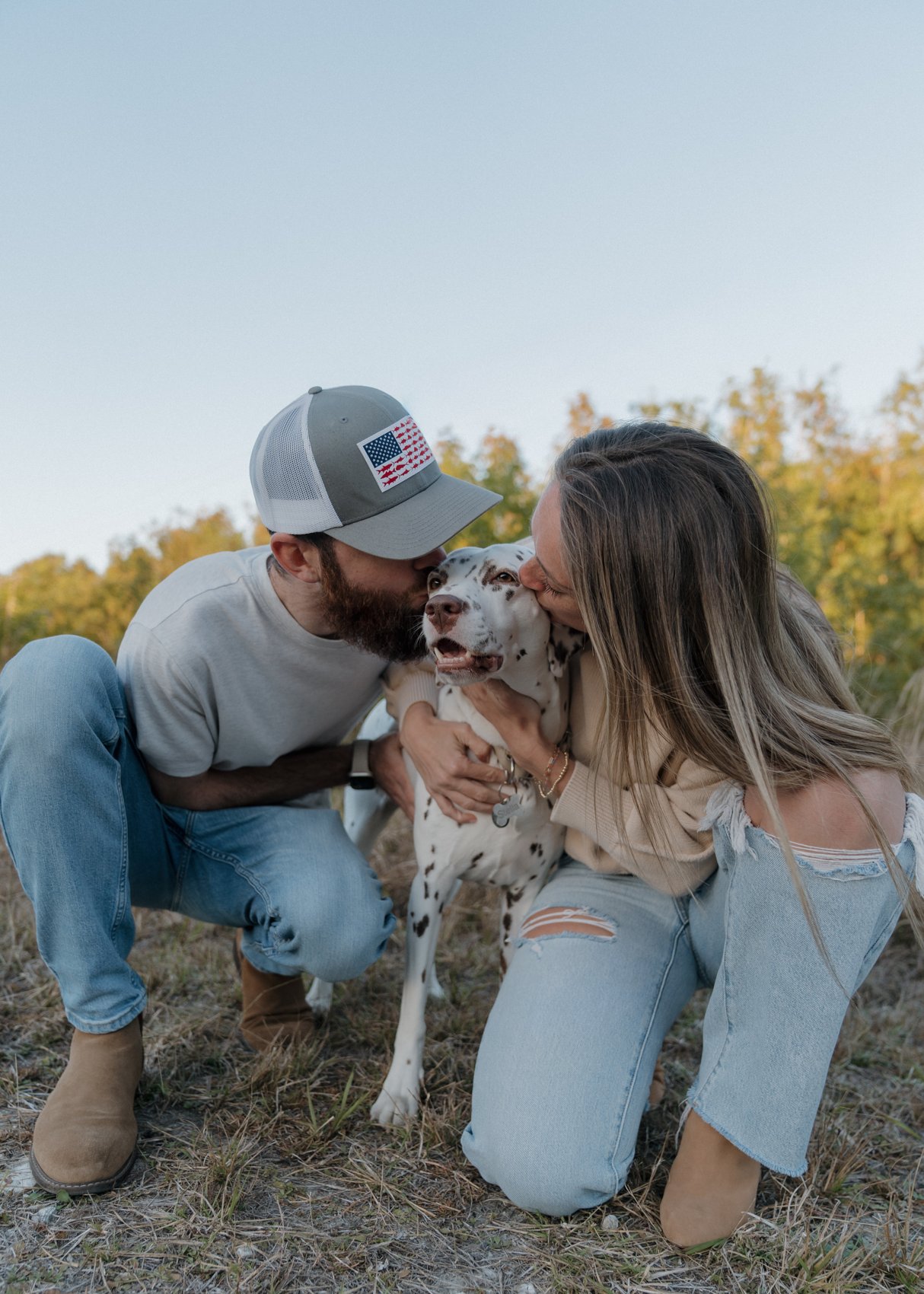 Spot On founders kissing their Dalmatian